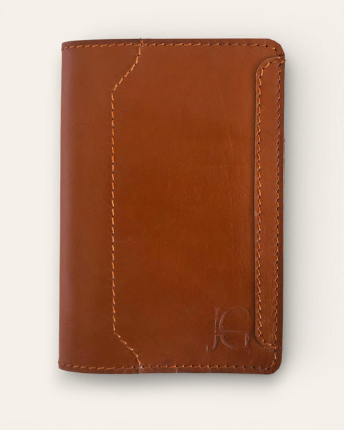 A real leather passport holder in brown color with multiple card slots and a cash slot