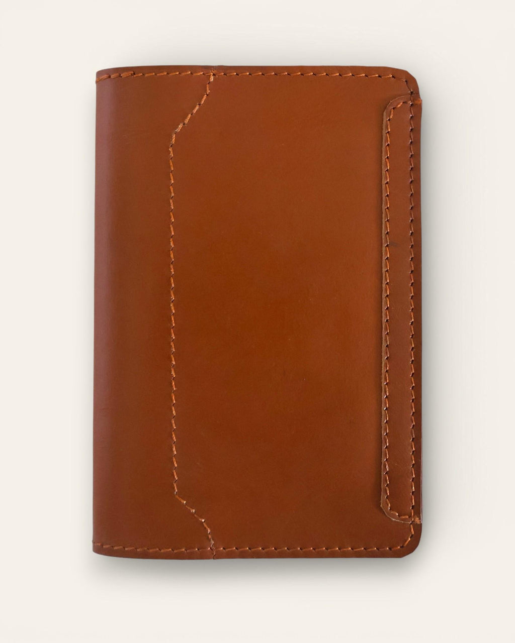 A real leather passport holder in brown color with multiple card slots and a cash slot