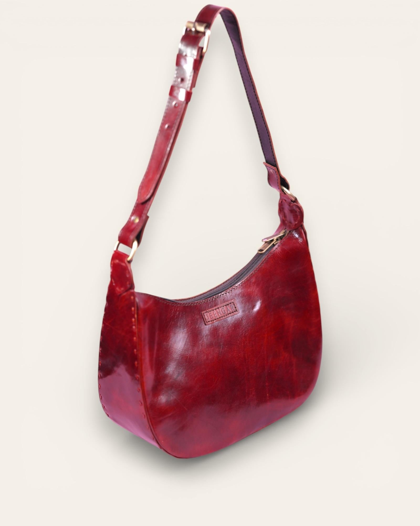 A red glossy real leather bag, it's hand stitched and made with real leather