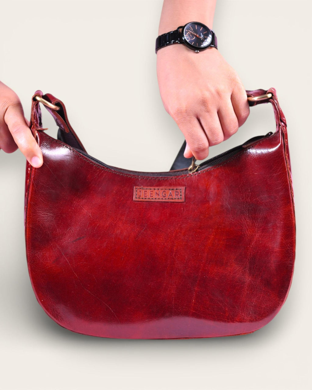 A red glossy real leather bag, it's hand stitched and made with real leather