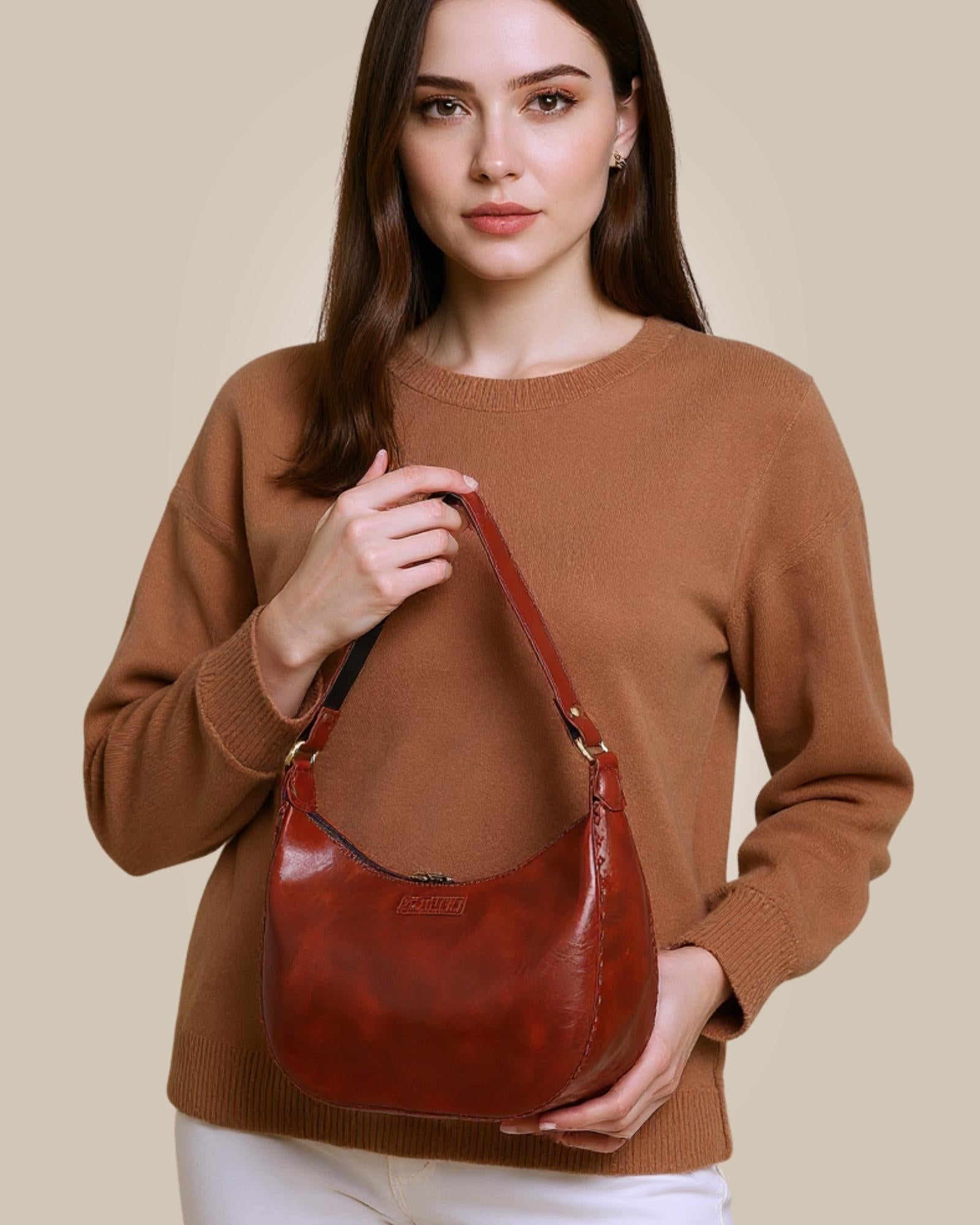 A red glossy real leather bag, it's hand stitched and made with real leather