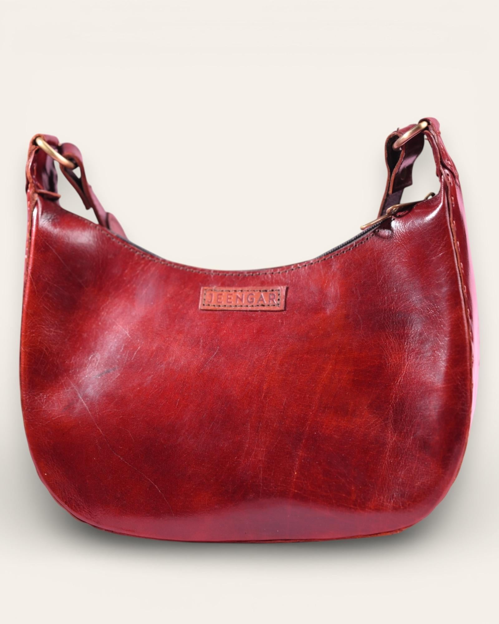 A red glossy real leather bag, it's hand stitched and made with real leather