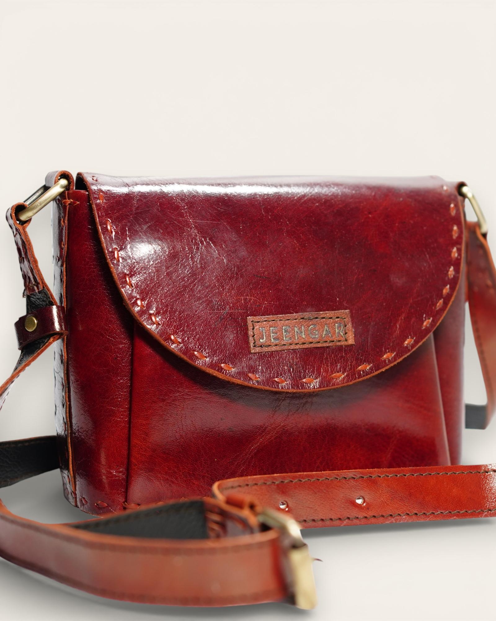 A red glossy small real leather sling bag, perfect for daily essentials