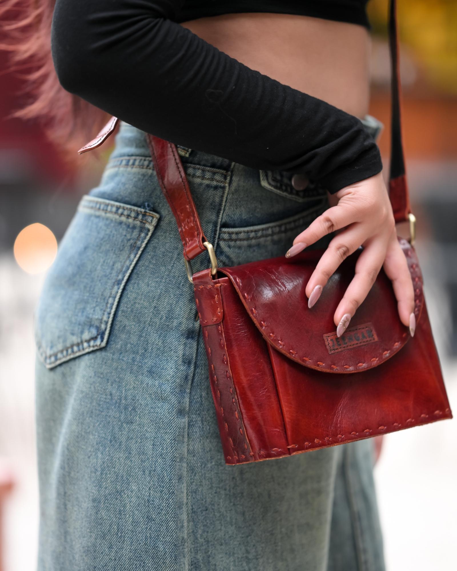 A red glossy small real leather sling bag, perfect for daily essentials