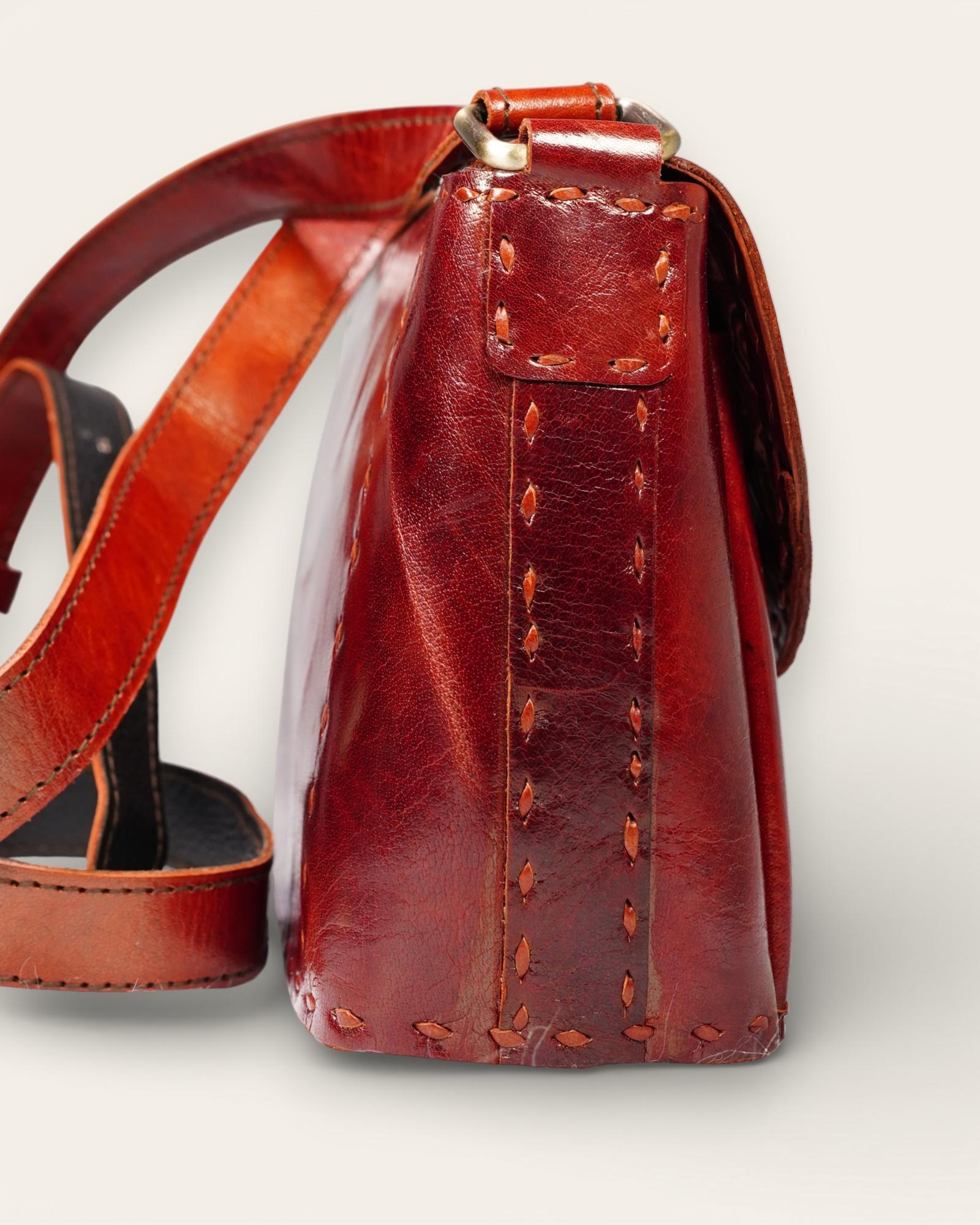 A red glossy small real leather sling bag, perfect for daily essentials