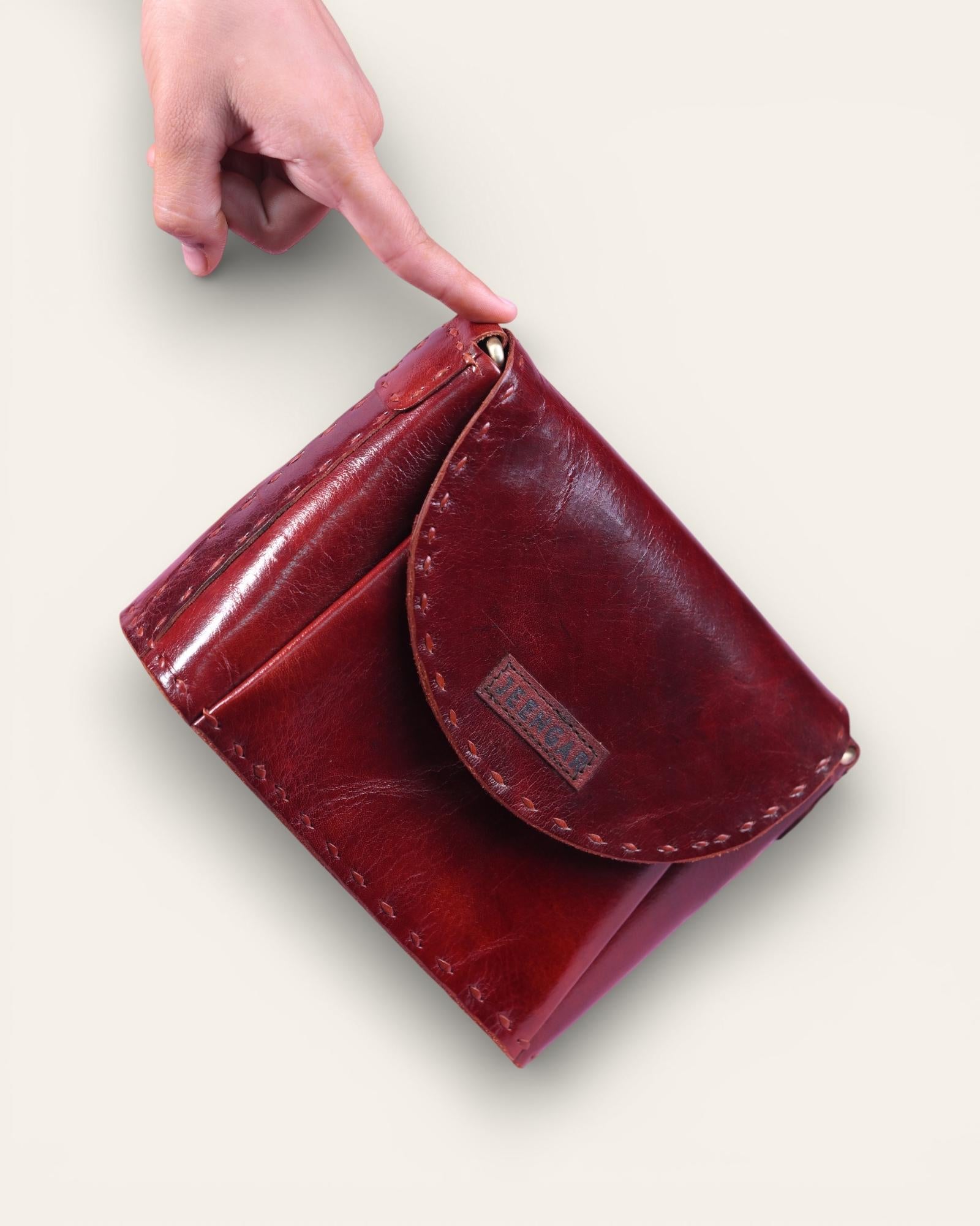 A red glossy small real leather sling bag, perfect for daily essentials