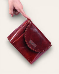 A red glossy small real leather sling bag, perfect for daily essentials
