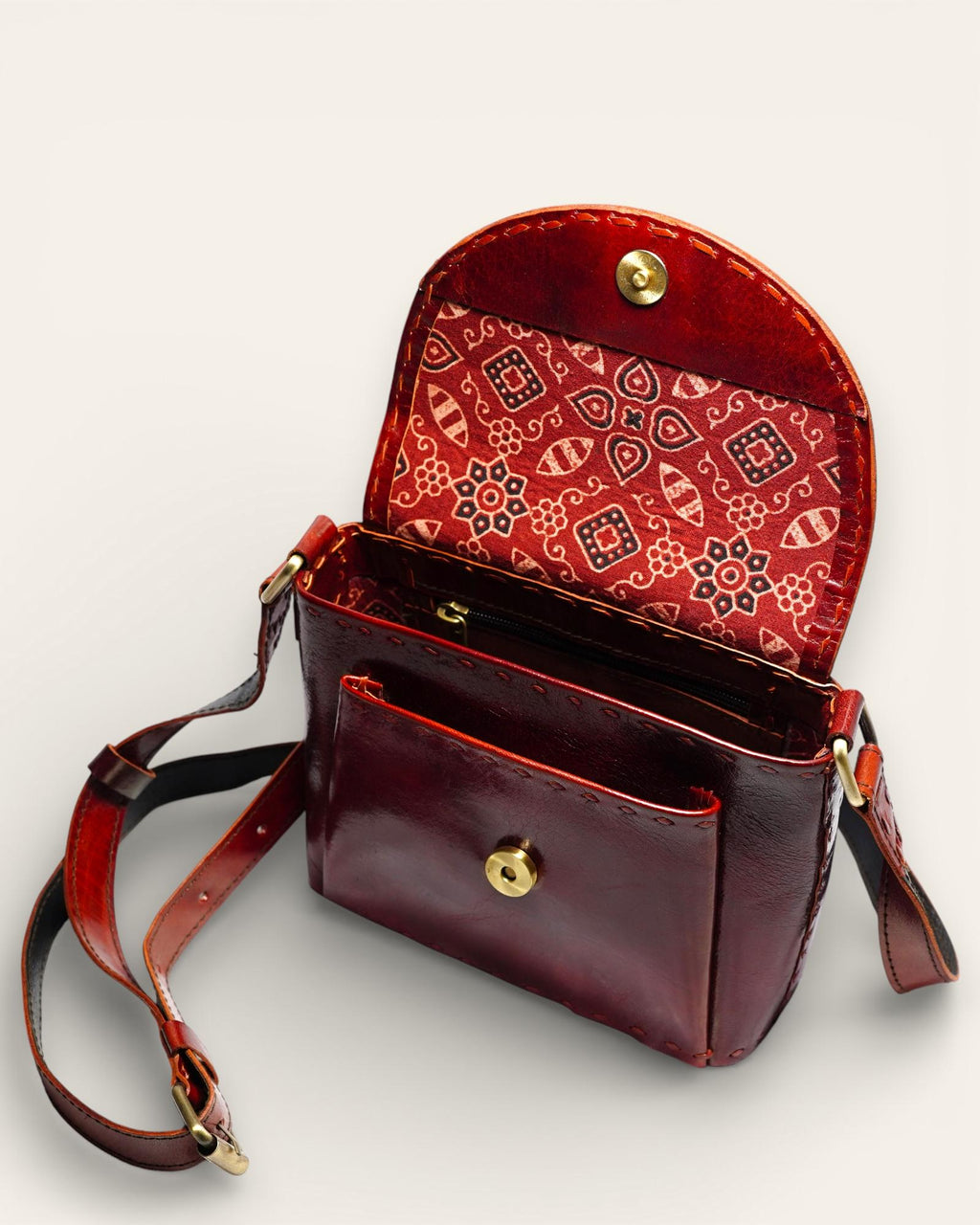 A red glossy small real leather sling bag, perfect for daily essentials