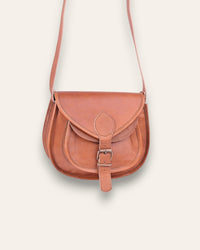 A real leather brown tan sling saddle bag for women and men