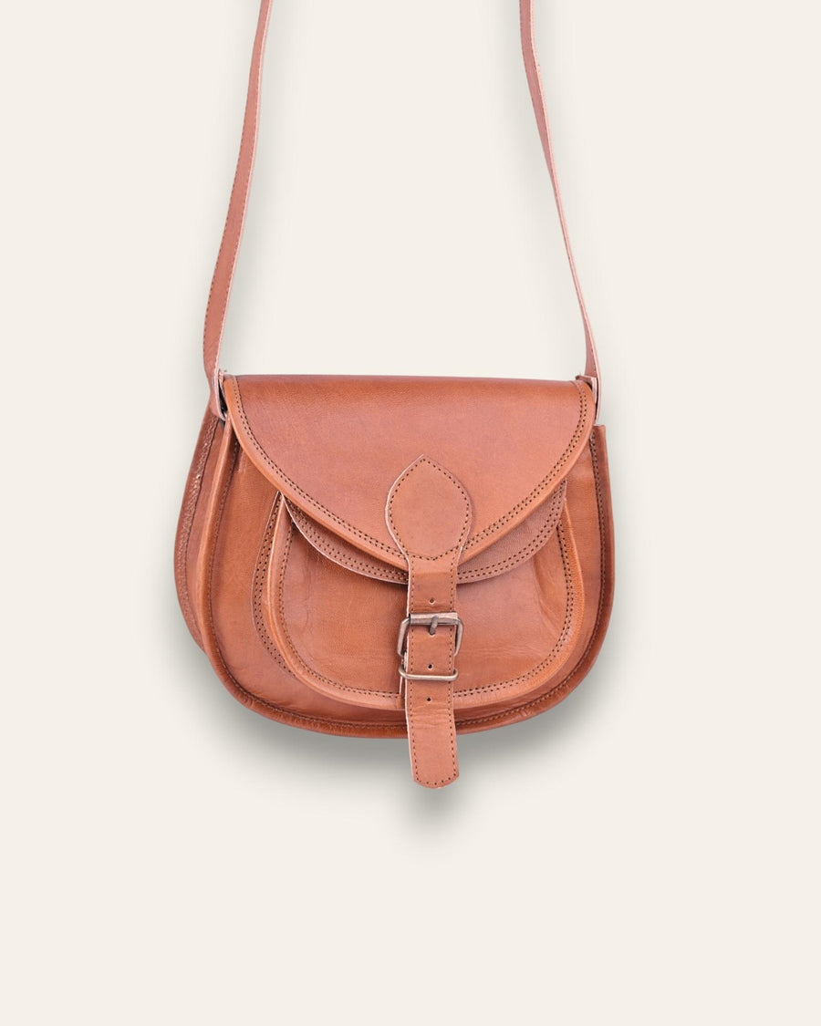 A real leather brown tan sling saddle bag for women and men