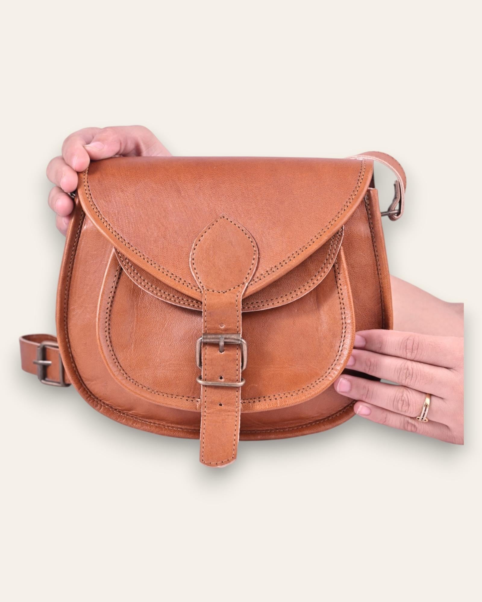 A real leather brown tan sling saddle bag for women and men