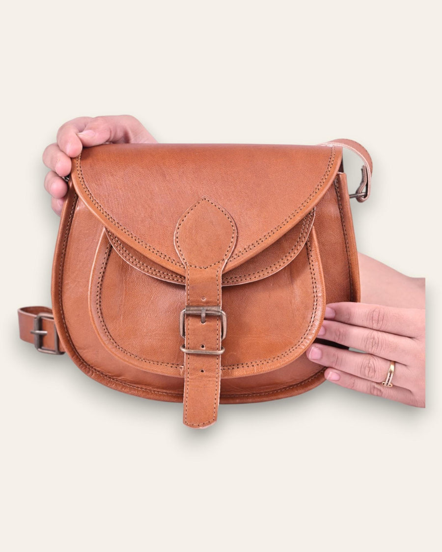 A real leather brown tan sling saddle bag for women and men