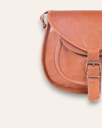 A real leather brown tan sling saddle bag for women and men