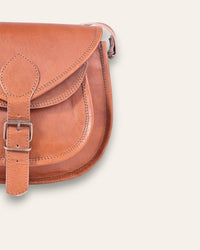 A real leather brown tan sling saddle bag for women and men