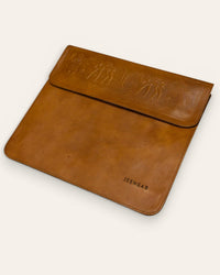 The Barmer Tech Sleeve, a handcrafted tan full-grain leather iPad and MacBook sleeve featuring a hand-embossed desert camel motif by Jeengar.