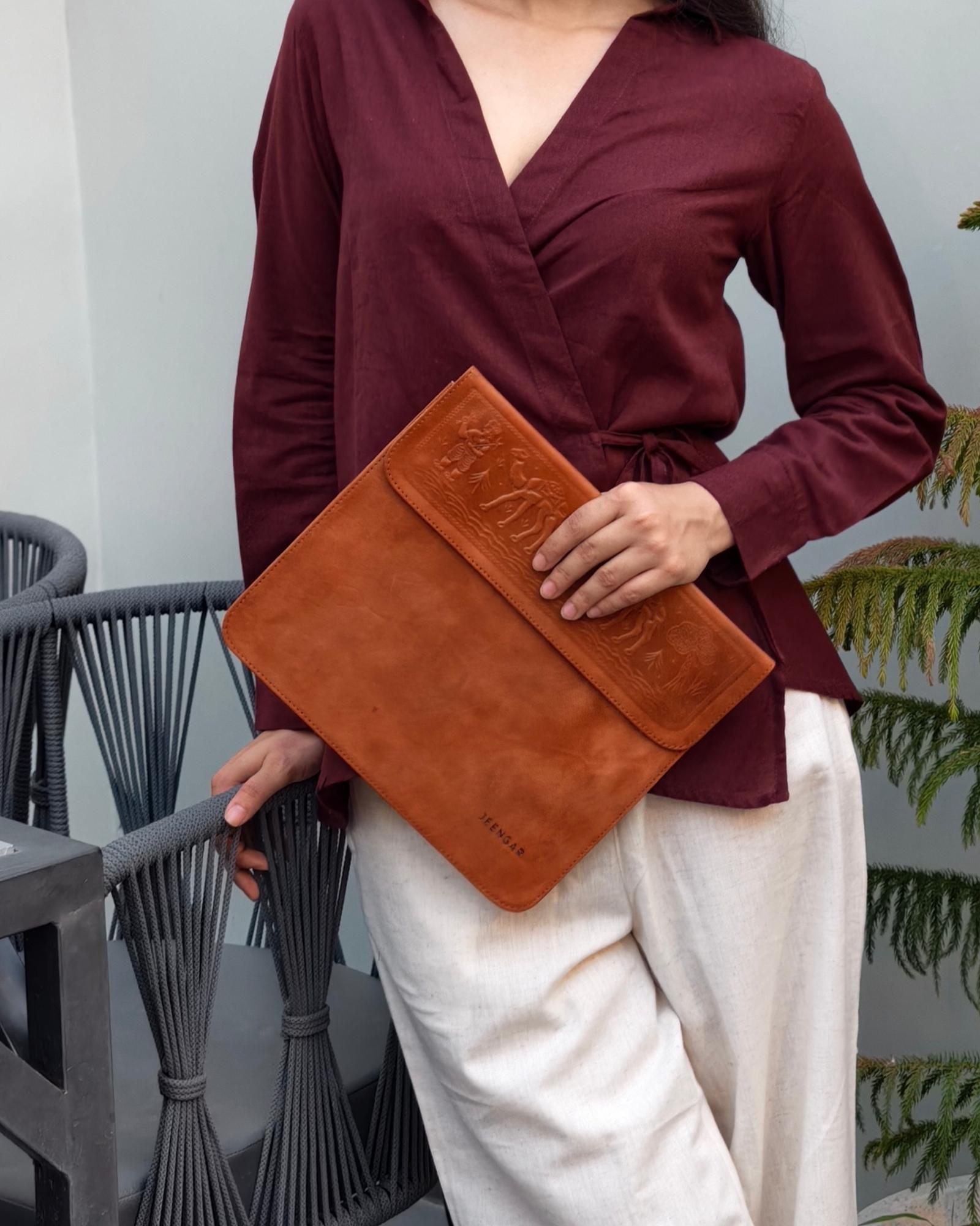 The Barmer Tech Sleeve, a handcrafted tan full-grain leather iPad and MacBook sleeve featuring a hand-embossed desert camel motif by Jeengar.
