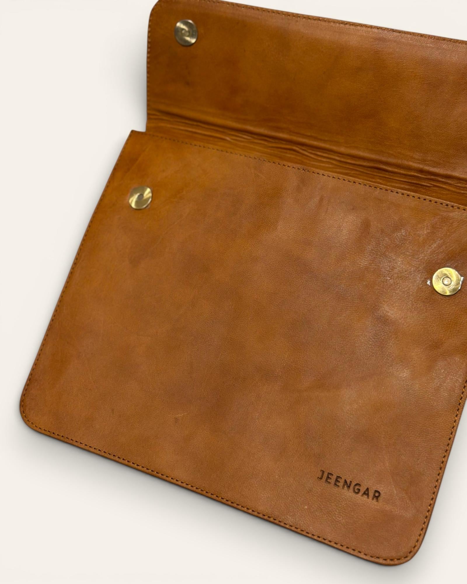 The Barmer Tech Sleeve, a handcrafted tan full-grain leather iPad and MacBook sleeve featuring a hand-embossed desert camel motif by Jeengar.
