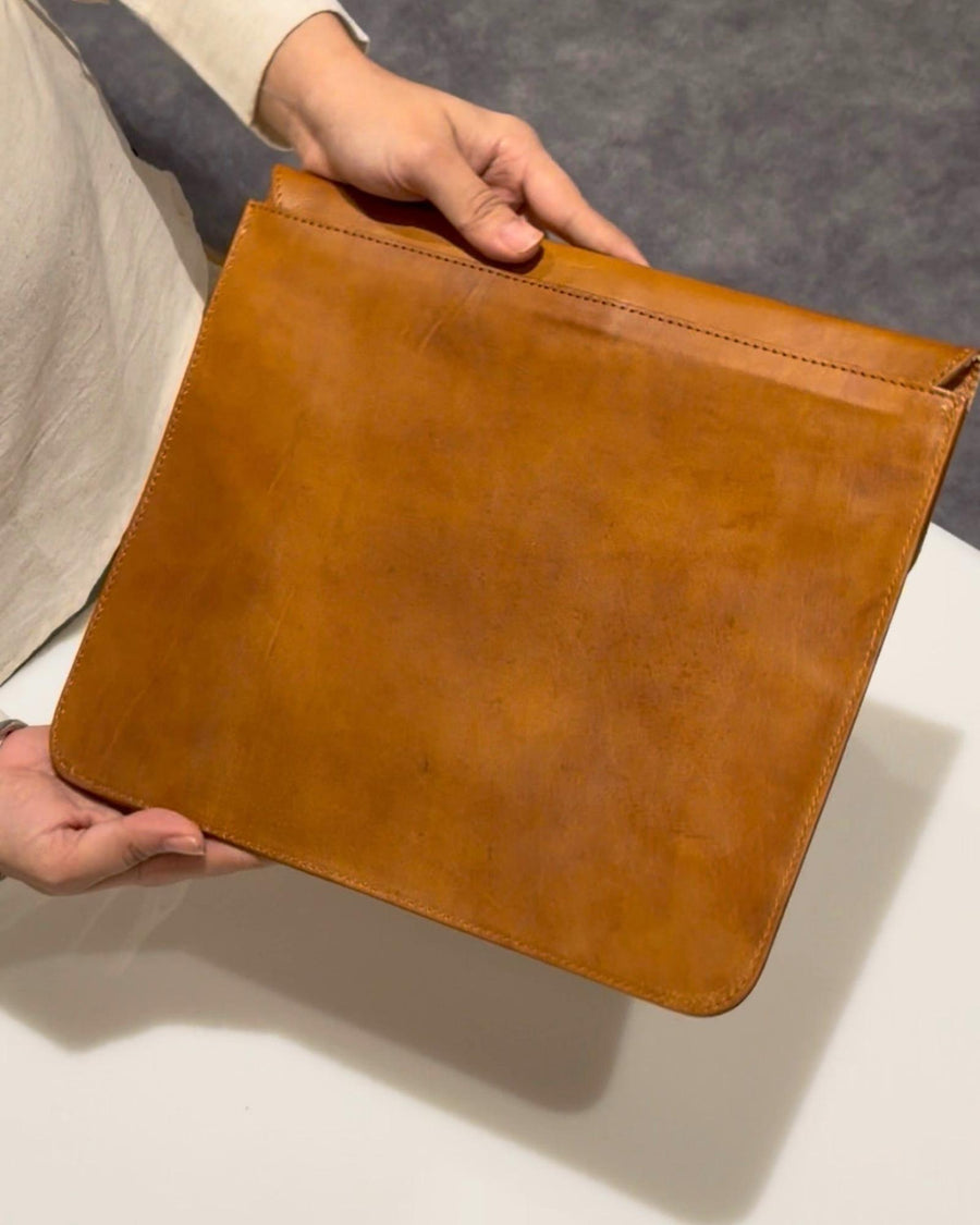 The Barmer Tech Sleeve, a handcrafted tan full-grain leather iPad and MacBook sleeve featuring a hand-embossed desert camel motif by Jeengar.