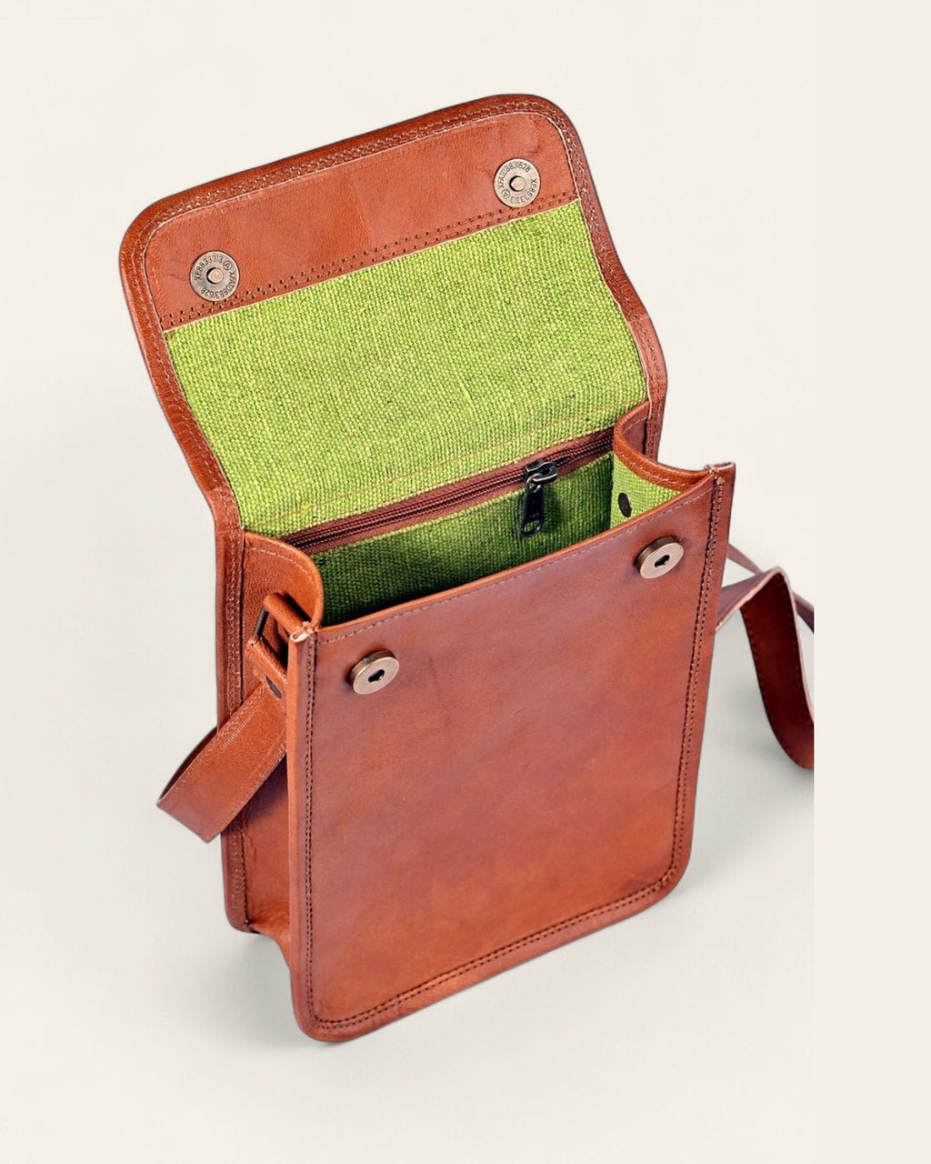 The Phalodi Sling open, revealing its bright-green canvas interior