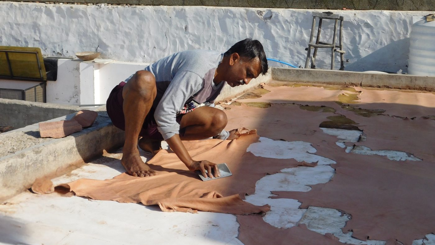 A Jeengar artisan hand-finishing leather hides in Barmer, Rajasthan